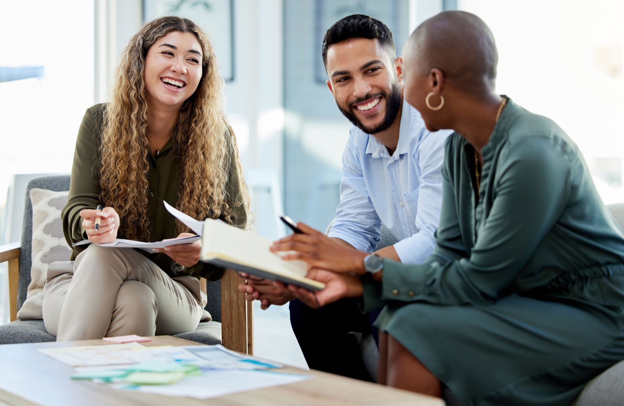 Happy business people smile during a planning meeting in a startup marketing agency office. Diversity, collaboration and teamwork in a healthy work environment in an international advertising company.