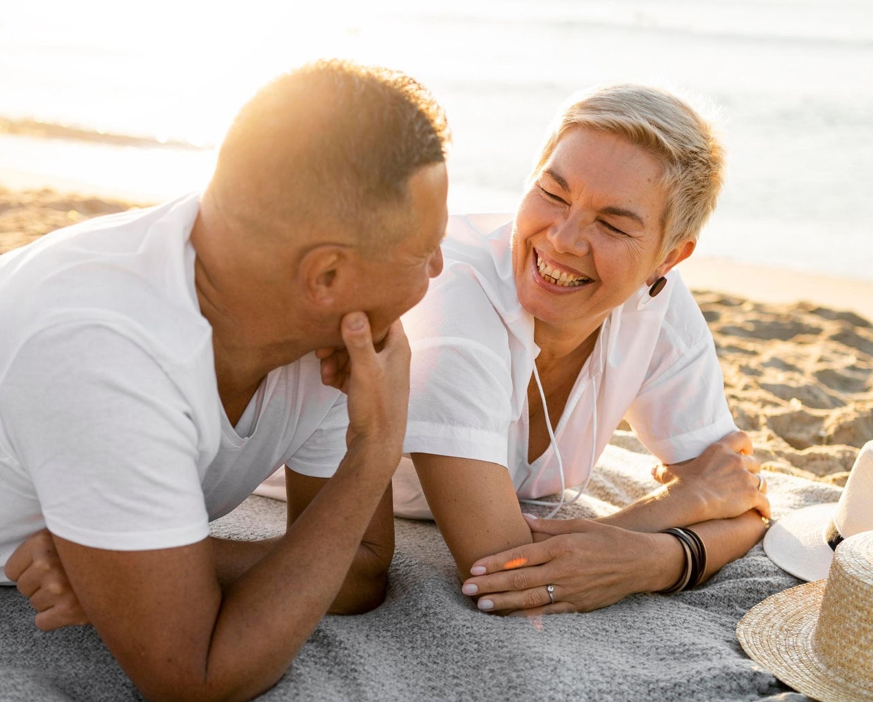 Canva-couple-talking-beach-sunset