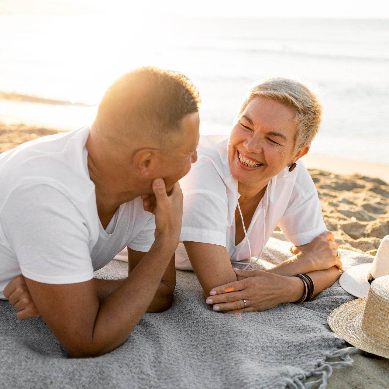 Canva-couple-talking-beach-sunset