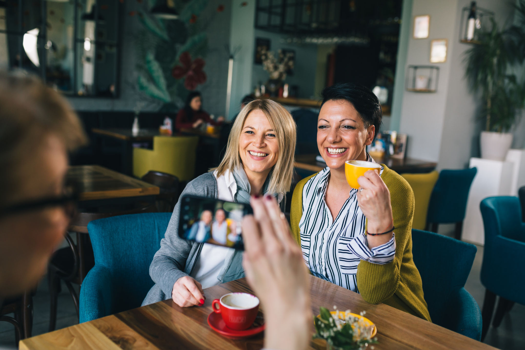 women friends having fun in cafe