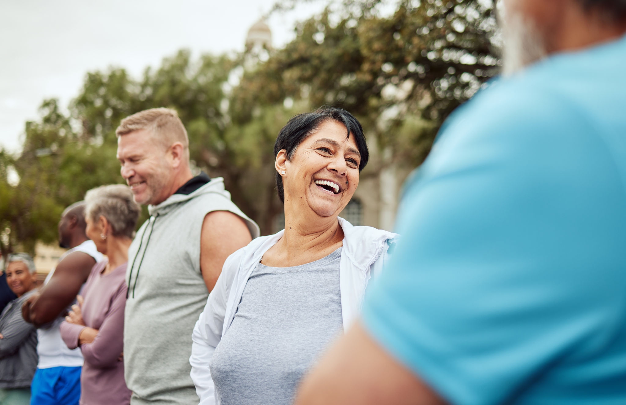 Talking, fitness or happy senior friends bonding or laughing for team building or training support. Runners community or healthy mature people with body goals after running exercise or cardio workout.