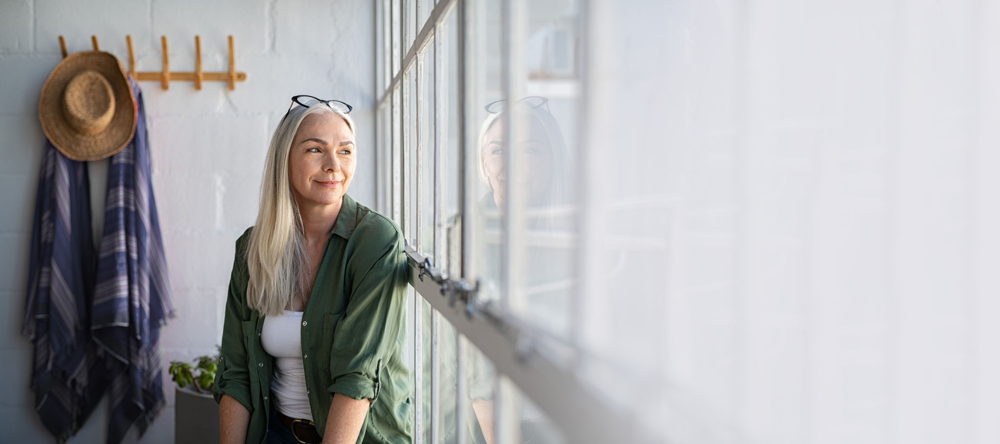 Woman sitting by a window looking outside