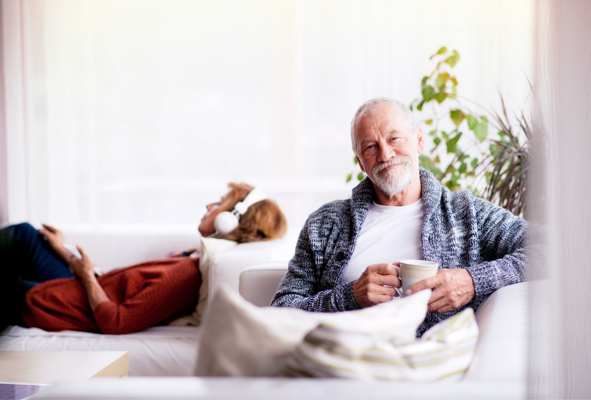 Canva-senior-couple-couch